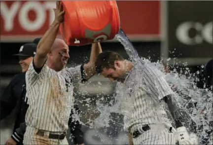  ?? JULIE JACOBSON — THE ASSOCIATED PRESS ?? Yankees’ Brett Gardner, left, douses Neil Walker after Walker hit a walkoff single to drive in Gary Sanchez for the winning run against Athletics in the 11th inning.