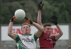  ??  ?? Matthew O’Hanlon jumps with Castletown’s Stephen Moloney.