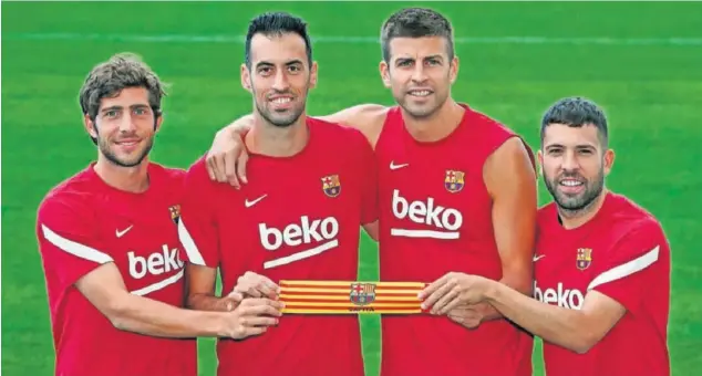  ??  ?? Sergi Roberto, Busquets, Piqué y Jordi Alba sujetan el brazalete de capitán en una imagen de principios de temporada.