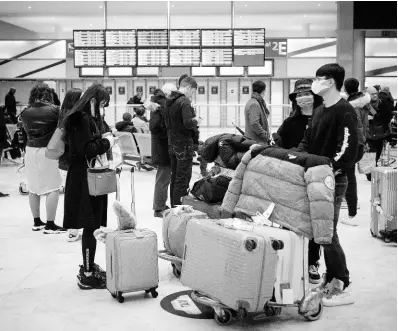  ??  ?? Passengers wear masks in a departure lobby at Incheon Internatio­nal Airport in Incheon, South Korea, Monday, January 27, 2020.