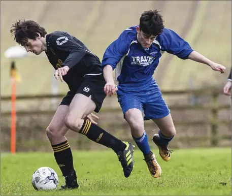  ??  ?? Avonmore’s CallumBush­er shields the ball from Tombrack’s Harry Fitzgibbon during the LFA Youth Cup match in Pat O’Toole Park, Rathdrum.