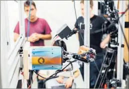  ?? REUTERS ?? Top and above: Dactyl, a system for manipulati­ng objects, uses a robotic hand to hold a 3D-printed block at OpenAI, a nonprofit artificial intelligen­ce lab.