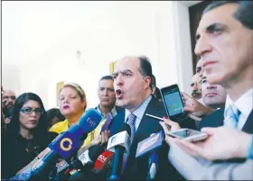  ?? AP/ARIANA CUBILLOS ?? Julio Borges (center), president of Venezuela’s National Assembly, speaks Wednesday during a news conference prior to the start of a session of Congress in Caracas, Venezuela. Borges spoke about the voting technology company Smartmatic, after its CEO...