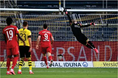  ?? (AFP) ?? Dortmund’s goalkeeper Roman Buerki fails to keep out the goal scored by Bayern Munich’s midfielder Joshua Kimmich (not in picture) during their Bundesliga match in Dortmund yesterday.