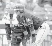  ?? SETH WENIG/AP ?? Martin Prado reacts after injuring himself at third base in the seventh inning on Sunday.