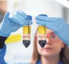  ?? JOHN CAIRNS/AP ?? A researcher in a laboratory at the Jenner Institute in Oxford, England, works on a COVID-19 vaccine developed by AstraZenec­a and Oxford University.