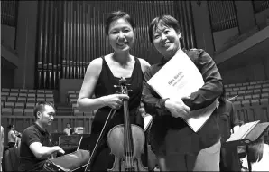  ??  ?? Conductor Zhang Xian and Taiwan violist Huang Hsin-yun at a rehearsal at the National Center for the Performing Arts in Beijing.