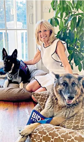  ??  ?? Jill Biden with Major, a dog adopted from the Delaware Humane Associatio­n, left, and Champ, their other dog