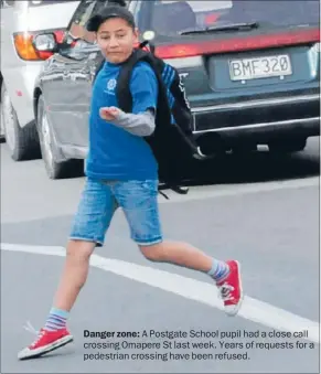  ??  ?? Danger zone: A Postgate School pupil had a close call crossing Omapere St last week. Years of requests for a pedestrian crossing have been refused.