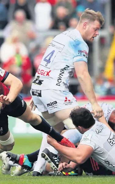  ?? Pictures: PA ?? Munster’s Darren Sweetnam is tackled by Freddie Clarke and Val Rapava Ruskin