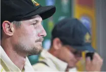  ?? PHOTO: GETTY IMAGES ?? Shame faced . . . Australian cricketers Cameron Bancroft (left) and Steve Smith face the media yesterday after admitting to ball tampering.