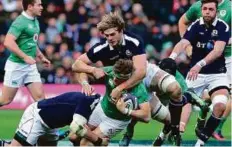  ?? AP ?? Scotland’s Richie Gray (top) tackles Ireland’s Jamie Heaslip during the Six Nations match at BT Murrayfiel­d Stadium in Edinburgh on February 4.