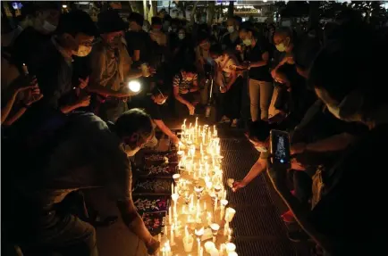  ?? Yan Zhao, AFP/Getty Images ?? Protesters light candles at a vigil Thursday in Hong Kong to remember the victims of the 1989 Tiananmen Square crackdown by the Chinese government.
