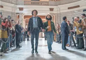  ?? PROVIDED BY NIKO TAVERNISE/NETFLIX ?? Abbie Hoffman (Sacha Baron Cohen, left) and Jerry Rubin (Jeremy Strong) arrive for court in Aaron Sorkin's “The Trial of the Chicago 7,” which won best ensemble cast, motion picture, on Sunday.