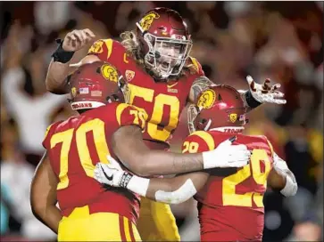  ?? Jae C. Hong Associated Press ?? TWO NFL scouts say that USC’s most interestin­g draft prospects are on the line, particular­ly left tackle Chuma Edoga (70) and center Toa Lobendahn ( 50), shown celebratin­g with Vavae Malepeai.