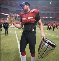  ?? THE CANADIAN PRESS/PAUL CHIASSON ?? Calgary Stampeders offensive lineman Dan Federkeil holds the Grey Cup trophy after it broke into two pieces in Vancouver, B.C., Nov. 30, 2014. Federkeil, now retired, faces a two-game suspension if he returns to the CFL after testing positive for a...