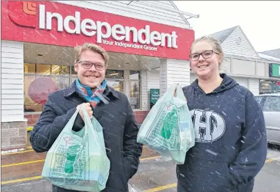  ?? MAUREEN COULTER/THE GUARDIAN ?? Tristan LeClair, left, of Stratford and Jordon Havenga of Cornwall do some last-minute grocery shopping Thursday before the winter storm. LeClair and Havenga picked up some storm chips, milk and cookies and planned to spend the day cuddled up watching...