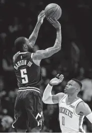  ?? Matthew Stockman / Getty Images ?? The Nuggets’ Will Barton rises above Russell Westbrook for a shot in the first quarter.