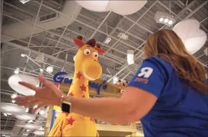  ?? Houston Chronicle file photo ?? A Geoffrey the Giraffe mascot in 2019 at the Houston Galleria mall in Houston, where Toys R Us made a brief comeback along with a store in Paramus, N.J. Under new owner WHP Global, the brand is making a retail comeback insider many Macy’s department stores nationally.