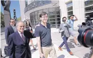  ?? SETH WENIG/ASSOCIATED PRESS ?? Martin Shkreli, center, leaves federal court in New York on Friday. The former pharmaceut­ical CEO has been convicted of deceiving investors in two hedge funds.