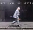  ?? — Reuters ?? A businessma­n walks past the headquarte­rs of Australia’s Reserve Bank in Sydney.