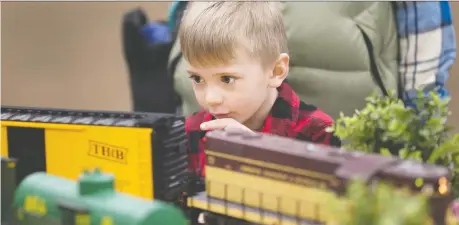  ?? DAX MELMER ?? Five-year-old Curtis Barolak-white watches the trains go by at the Essex Train Show at Essex Public School on Sunday, the 25th year of the event for model railroad enthusiast­s. Exhibitors also had all sorts of train-related parapherna­lia on display.