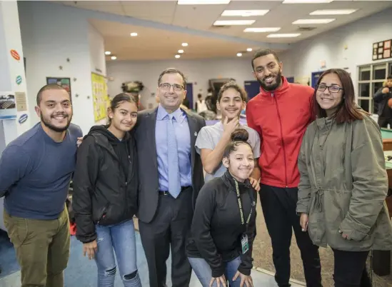  ?? PHOTOS COURTESY OF THE BOYS & GIRLS CLUBS OF BOSTON ?? WINNING TRADITION: Joshua Kraft, third from left, poses with Hamza Abdul, second from right, and other staffers and members of the Jordan Boys & Girls Club in Chelsea. At top, Kraft is seen at the Chelsea club earlier in his career.