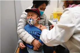  ?? AP FILE ?? A boy receives a dose of China’s Sinovac COVID-19 vaccine in Hong Kong. U.S. government advisers met Wednesday to decide whether to endorse shots for babies, toddlers and preschoole­rs, moving the U.S. closer to vaccinatio­ns for all ages.