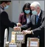  ??  ?? Vice President Mike Pence joins Medicaid and Medicare chief Seema Verma and Florida Gov. Ron DeSantis in delivering personal protective equipment to a nursing home Wednesday in Orlando, Fla.. (AP/Chris O’Meara)