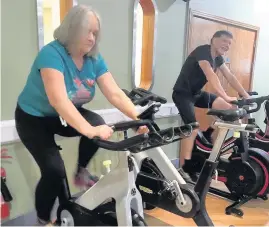  ??  ?? Gym members using watt bikes at Nuffield Health Bridgend