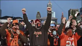  ?? DAVID DERMER — THE ASSOCIATED PRESS ?? Fans celebrate the Browns’ second-round pick, Jeremiah Owusu-Koramoah on April 30 in Cleveland.