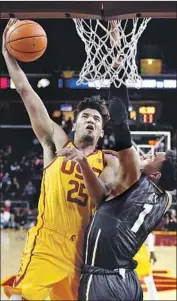  ?? Mark J. Terrill Associated Press ?? BENNIE BOATWRIGHT, left, of USC goes to the basket against Tyler Bey of Colorado in the first half.