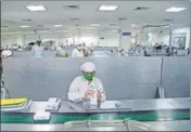  ?? ANI ?? Employees wear protective suits and masks while working inside a laboratory in Jammu on Tuesday.