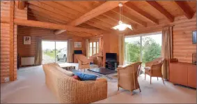  ??  ?? ROOM TO MOVE: The log cabin has a spacious living area with large windows