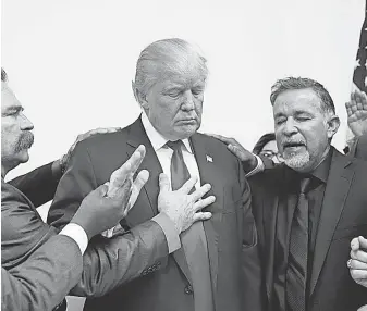  ?? EVAN VUCCI EVAN VUCCI, AP ?? Pastors from the Las Vegas area pray with Republican presidenti­al candidate Donald Trump.