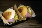  ?? PHOTOS BY DREW MAYNARD VIA THE NEW YORK TIMES ?? Rabbit sliders are served at Black Rabbit in downtown Nashville. Chef Trey Cioccia’s new venture is near Printer’s Alley and offers up drinks and food that call back to the downtown street’s heyday as a nightlife hot spot.