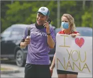  ?? (AP/Jessie Wardarski) ?? Corey Cappelloni and his girlfriend, Susan Kamenar, talk to his grandmothe­r Ruth Andres, 98, who is isolated in her fourth-floor bedroom at Allied Services Skilled Nursing & Rehab Center in Scranton, Pa., on June 19. Cappelloni raised more than $24,000 for older adults in isolation amid the coronaviru­s pandemic by running roughly 218 miles from Washington, D.C., to Scranton in seven days.