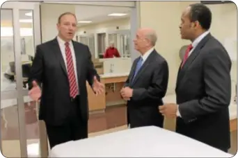  ??  ?? From left, St. Mary Medical Center President and CEO Greg Wozniak, St. Mary Chairman of the Board Frank Guarrieri and St. Mary board member Vernon Bramble tour one of the new patient rooms at St. Mary’s emergency department.