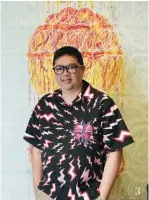  ??  ?? 3
3 Rhett Eala poses in front of one of his abstract paintings, which are on display in the pop-up