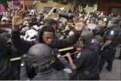  ?? JOHN MINCHILLO — THE ASSOCIATED PRESS FILE ?? Police and protesters converge during a demonstrat­ion Sept. 23 in Louisville, Ky.