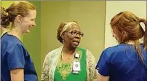  ?? CONTRIBUTE­D BY DANA JOHNSON ?? Velma Blackwell (center) bids farewell to Northside Hospital Cherokee colleagues Renee Reece and Katie Silakowski at her retirement celebratio­n on July 19.