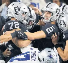  ?? RON JENKINS THE ASSOCIATED PRESS ?? Las Vegas Raiders place kicker Daniel Carlson (2) is congratula­ted after kicking the game-winning field goal in overtime against Dallas.