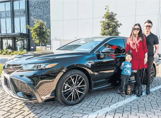  ?? RENÉE S. SUEN PHOTOS FOR THE TORONTO STAR ?? Oakville-based Frank Huang, his wife, Karen, and their son, Keith, have been relying on their 2021 Toyota Camry Hybrid LE for their daily needs and road trips.