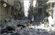  ?? THE ASSOCIATED PRESS ?? Syrians inspect damaged buildings after airstrikes hit in Aleppo, Syria, on Saturday.