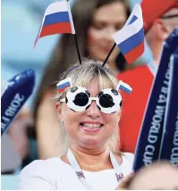  ??  ?? A Russian supporter celebrates on the tribune prior the Group B match between Portugal and Spain at the 2018 soccer World Cup in the Fisht Stadium in Sochi, Russia, yesterday.