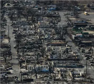  ?? JAE C. HONG — THE ASSOCIATED PRESS ?? A general view shows the aftermath of a wildfire in Lahaina, Hawaii, Thursday. Hawaii's governor vowed to protect local landowners from being “victimized” by opportunis­tic buyers when Maui rebuilds from deadly wildfires that incinerate­d a historic island community.