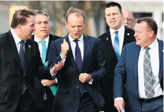  ?? JONATHAN NACKSTRAND/AFP/ GETTY IMAGES ?? European Council President Donald Tusk, centre, walks with colleagues at an EU summit in Sweden Friday. He said the EU had completed the internal work to approve the next phase of Brexit transition talks, but “much more progress” was needed from the...