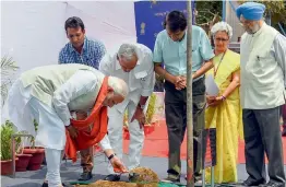  ?? — PTI ?? Prime Minister Narendra Modi plants a sapling during the foundation stone- laying ceremony of the upcoming office complex for the commerce department — Vanijya Bhavan— at Akbar Road in New Delhi on Friday.