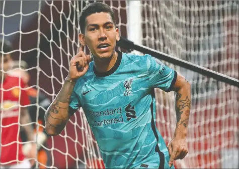  ?? GETTY IMAGES — ?? Liverpool's Roberto Firmino celebrates after scoring one of his two goals against Manchester United yesterday.