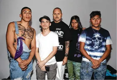  ?? Photos by Jackie Molloy / New York Times ?? Willy Chavarria, center, with some of the street-cast models from his menswear show July 24. His clothes draw from what he terms a So-Cal Chicano minimalism.